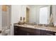 Elegant bathroom with granite countertop, dark wood cabinetry, and modern fixtures at 26355 N 79Th Dr, Peoria, AZ 85383