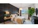 Stylish bedroom featuring a decorative accent wall, pendant light, and large window at 26355 N 79Th Dr, Peoria, AZ 85383
