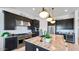 Modern kitchen with granite countertops, stainless steel appliances, and dark cabinets with ample storage space at 26355 N 79Th Dr, Peoria, AZ 85383