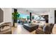 Open-concept living area with tile floors, a comfortable sofa, and scenic outdoor views through large windows at 26355 N 79Th Dr, Peoria, AZ 85383