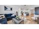 Cozy living room with stylish furniture, a kitchen view, and an inviting atmosphere at 26391 N 79Th Dr, Peoria, AZ 85383
