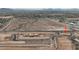 An aerial view of new construction in the desert with a winding road, houses, and vast desert landscape at 2823 N Arroyo Grande Ave, Casa Grande, AZ 85122