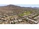 Desert community aerial shot featuring well maintained homes with pools and landscaping alongside a pristine golf course at 3045 W Feather Sound Dr, Phoenix, AZ 85086