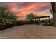 Charming back patio with desert landscaping, pergola with outdoor seating, and stunning sunset views at 3045 W Feather Sound Dr, Phoenix, AZ 85086