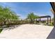 Charming back patio with desert landscaping, pergola with outdoor seating, and bright skies at 3045 W Feather Sound Dr, Phoenix, AZ 85086