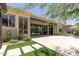 Expansive backyard with travertine patio, artificial grass, and folding doors that seamlessly connect indoor-outdoor living at 3045 W Feather Sound Dr, Phoenix, AZ 85086