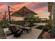 Outdoor patio area with desert landscape, comfortable seating and an umbrella for shade at 3045 W Feather Sound Dr, Phoenix, AZ 85086