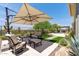 Enjoy outdoor living in this backyard featuring synthetic grass, desert landscape, and umbrella seating at 3045 W Feather Sound Dr, Phoenix, AZ 85086