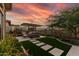 Outdoor patio features artificial grass, pavers, seating area, and a beautiful desert landscape at 3045 W Feather Sound Dr, Phoenix, AZ 85086