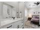 Modern bathroom with double vanity and view into the bedroom at 3045 W Feather Sound Dr, Phoenix, AZ 85086