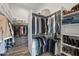 Walk-in closet with custom shelving and ample storage space for clothes and shoes at 3045 W Feather Sound Dr, Phoenix, AZ 85086