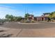 Clubhouse exterior showcasing flags, desert landscaping, and circle driveway at 3045 W Feather Sound Dr, Phoenix, AZ 85086