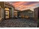 Inviting courtyard with comfortable seating area, decorative plants, stone accents, and brick pavers at 3045 W Feather Sound Dr, Phoenix, AZ 85086