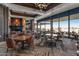 Elegant dining room with fireplace, large windows boasting picturesque views, and tables at 3045 W Feather Sound Dr, Phoenix, AZ 85086