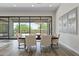 Elegant dining room with modern lighting fixture and outdoor views through large sliding glass doors at 3045 W Feather Sound Dr, Phoenix, AZ 85086