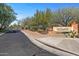 Street view of Anthem Golf & Country Club sign amidst lush landscaping along the entrance road at 3045 W Feather Sound Dr, Phoenix, AZ 85086