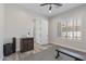Well-lit exercise room with window shutters, neutral walls, and a sleek Tonal home gym system on a gray rubber floor at 3045 W Feather Sound Dr, Phoenix, AZ 85086
