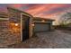 A gated entrance to the home with a brick surround and a paved driveway leading to a two car garage at 3045 W Feather Sound Dr, Phoenix, AZ 85086