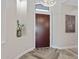 Stylish foyer boasting wood look tile floors, a chandelier and a well crafted wooden front door at 3045 W Feather Sound Dr, Phoenix, AZ 85086