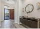 Foyer view featuring stylish wood-look tile, dark wood console table with mirror, and chandelier at 3045 W Feather Sound Dr, Phoenix, AZ 85086
