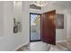 Bright foyer featuring wood look tile floors, a decorative chandelier and a striking wooden front door at 3045 W Feather Sound Dr, Phoenix, AZ 85086