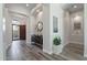 Bright foyer with wood-look tile, arched doorways, and a console table with decorative mirror at 3045 W Feather Sound Dr, Phoenix, AZ 85086