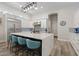 Modern kitchen with white cabinets, a large island with seating, and stainless steel appliances at 3045 W Feather Sound Dr, Phoenix, AZ 85086