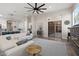 An open-concept living room that offers a fireplace, sliding glass door, and fan at 3045 W Feather Sound Dr, Phoenix, AZ 85086