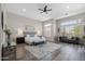 Spacious main bedroom with plantation shutters, accent seating, and wood-look tile at 3045 W Feather Sound Dr, Phoenix, AZ 85086