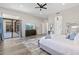 Bright main bedroom with access to patio and wood-look tile at 3045 W Feather Sound Dr, Phoenix, AZ 85086