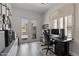 Bright office with ample desk space and decor, featuring an outdoor patio through sliding glass doors at 3045 W Feather Sound Dr, Phoenix, AZ 85086