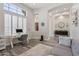 Bright home office with plantation shutters, views to foyer, and gray wood-look tile flooring at 3045 W Feather Sound Dr, Phoenix, AZ 85086