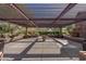 Expansive outdoor living area with pergola, fireplace, and lush greenery, providing a tranquil retreat for residents at 3045 W Feather Sound Dr, Phoenix, AZ 85086