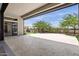 Covered patio with travertine pavers, views of a fenced backyard, and desert landscaping at 3045 W Feather Sound Dr, Phoenix, AZ 85086