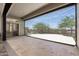 Covered patio with shade screen, travertine pavers, and views of a landscaped backyard at 3045 W Feather Sound Dr, Phoenix, AZ 85086