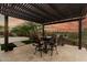 Outdoor dining area under pergola features seating, BBQ, desert landscape, and sunset views at 3045 W Feather Sound Dr, Phoenix, AZ 85086