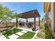 Pergola covered patio with desert landscape features BBQ and seating for outdoor dining at 3045 W Feather Sound Dr, Phoenix, AZ 85086