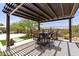 Pergola patio area with BBQ, desert landscape, and dining seating. Perfect for outdoor enjoyment at 3045 W Feather Sound Dr, Phoenix, AZ 85086