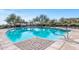 Community pool with lounge chairs and umbrellas, featuring a serene atmosphere and picturesque views for resident's enjoyment at 3045 W Feather Sound Dr, Phoenix, AZ 85086