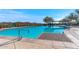 Sparkling community pool with lounge chairs, umbrellas, and mountain views, perfect for relaxing and unwinding under the sun at 3045 W Feather Sound Dr, Phoenix, AZ 85086