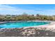 Large community pool with ample seating, umbrellas and serene surroundings, offering a refreshing escape for residents and guests at 3045 W Feather Sound Dr, Phoenix, AZ 85086