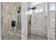 Modern shower featuring marble-look tile walls, a rain shower head, and a built-in bench at 3045 W Feather Sound Dr, Phoenix, AZ 85086