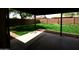 View of the spacious backyard with lush green lawn and tall block wall from covered patio at 3216 E Campo Bello Dr, Phoenix, AZ 85032