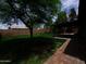 A spacious backyard featuring green grass and a covered patio with a brick extension at 3216 E Campo Bello Dr, Phoenix, AZ 85032