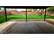 View of the spacious backyard with lush green lawn and tall block wall from covered patio at 3216 E Campo Bello Dr, Phoenix, AZ 85032