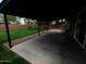 View of the spacious backyard with lush green lawn and tall block wall from covered patio at 3216 E Campo Bello Dr, Phoenix, AZ 85032