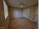 Bright bedroom featuring a ceiling fan, closet, and neutral-toned walls at 3216 E Campo Bello Dr, Phoenix, AZ 85032