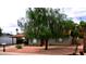 Charming single-story home featuring low maintenance landscaping, mature tree, and a cozy front porch at 3216 E Campo Bello Dr, Phoenix, AZ 85032