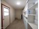 Spacious garage features ample storage with built-in shelves and cabinets with an exterior door at 3216 E Campo Bello Dr, Phoenix, AZ 85032