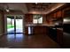 Modern kitchen with stainless steel appliances, wood cabinets, and a sliding door to the backyard at 3216 E Campo Bello Dr, Phoenix, AZ 85032